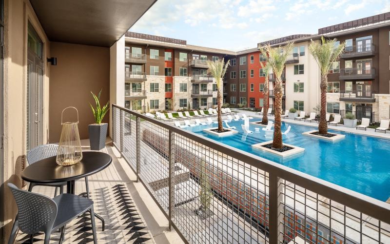 a balcony with a table and chairs