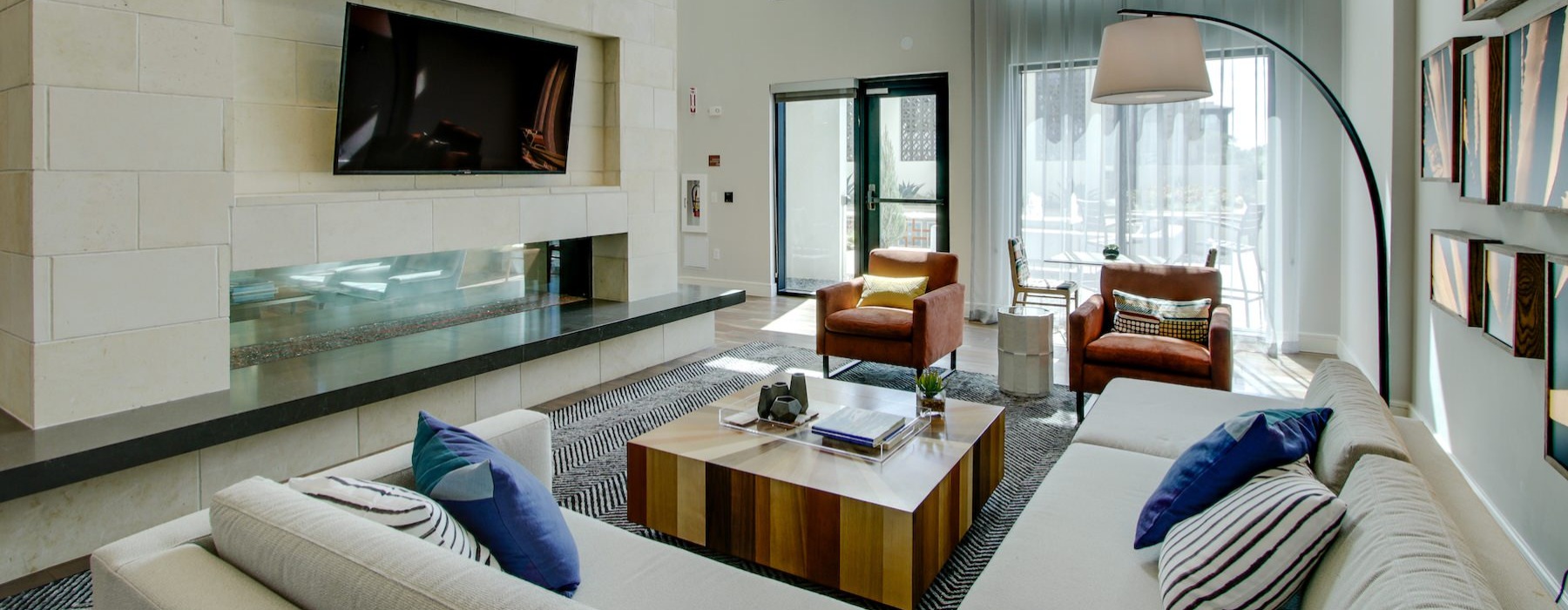 a clubroom with a tv, couch and chairs