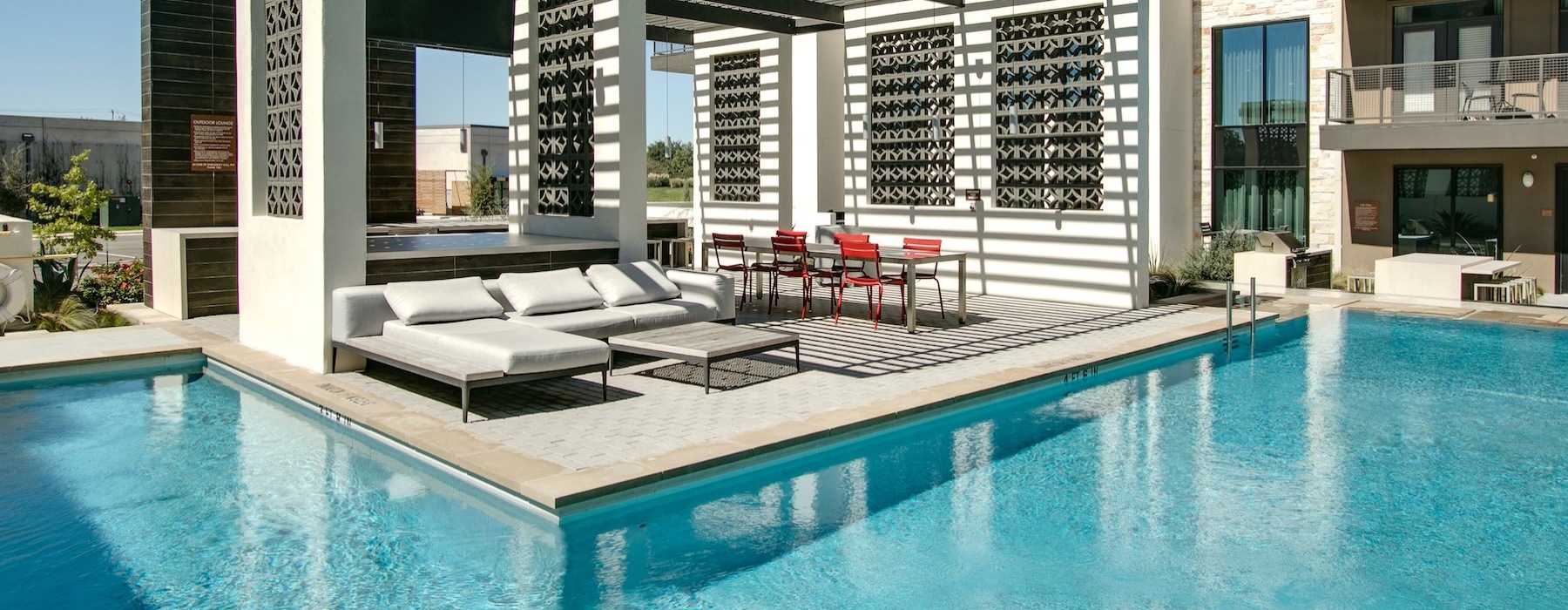 a swimming pool with a deck and a couch