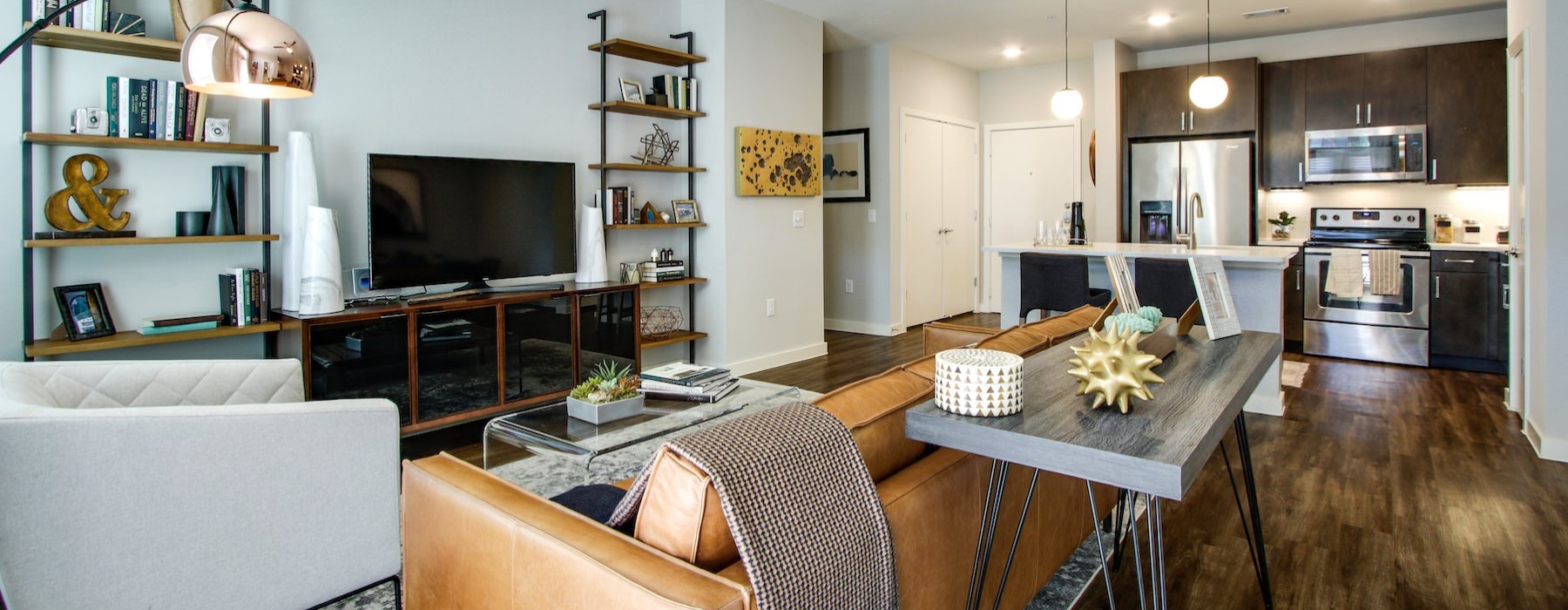 a living room with a tv, couch and table